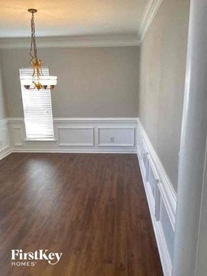 Charlotte house for rent - a dining room with wood floors and a chandelier