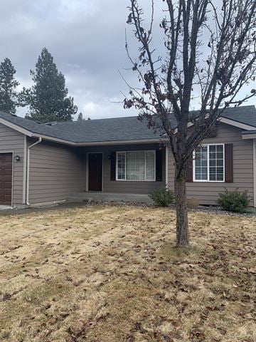 Coeur D Alene house for rent - a home with a tree in the front yard