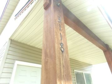 Coeur D' Alene house for rent - a close up of a porch post with a house in the background