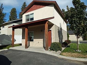 Coeur D' Alene house for rent - a white house with a red door and a sidewalk
