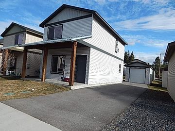 Coeur D Alene house for rent - a white house with a driveway in front of it