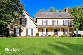 Collierville house for rent - a white house with a lawn in front of it
