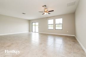 Wimauma house for rent - the spacious living room with tile flooring and a ceiling fan