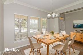 Cypress house for rent - A dining room with a wooden table set for a meal.