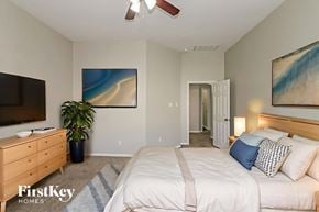 Cypress house for rent - A bedroom with a bed, dresser, and ceiling fan.