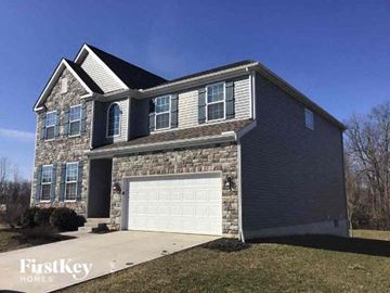 Lancaster house for rent - a brick house with a white garage door