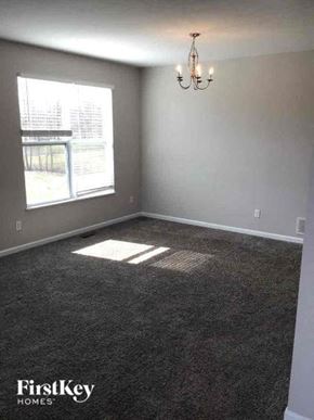 Lancaster house for rent - an empty room with a chandelier and a window