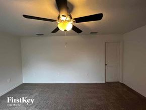 North Port house for rent - a bedroom with a ceiling fan and a white wall