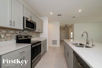 Davenport house for rent - A kitchen with a stove top oven and microwave above it.