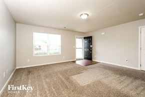 Lexington house for rent - A spacious room with a carpeted floor and a door leading to a balcony.