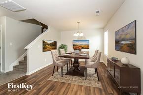 Lexington house for rent - A dining room with a wooden table and chairs, a painting on the wall, and a rug on the floor.