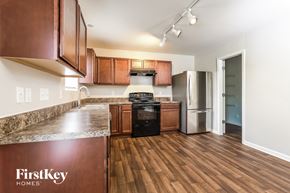 Lexington house for rent - A kitchen with wooden cabinets and a stove top oven.