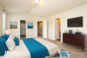 Lexington house for rent - A bedroom with a bed, dresser, and television.