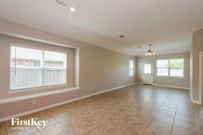 Baytown house for rent - A spacious room with a tiled floor and a ceiling fan.