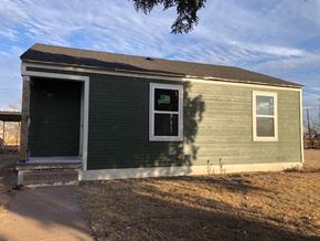 Snyder house for rent - a small green house with a door and a window