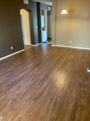El Paso apartment for rent - A room with wooden flooring and a light hanging from the ceiling.