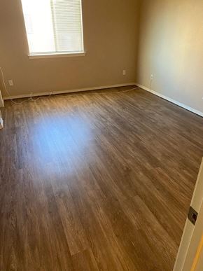 El Paso apartment for rent - A room with wooden flooring and a window.