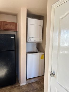 El Paso apartment for rent - A black refrigerator is next to a white dishwasher in a kitchen.