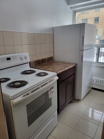 Toronto apartment for rent - a kitchen with a stove and a refrigerator