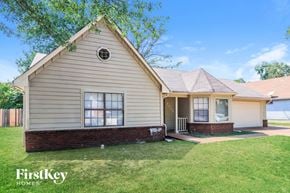 Memphis house for rent - A house with a well-kept lawn in front of it.
