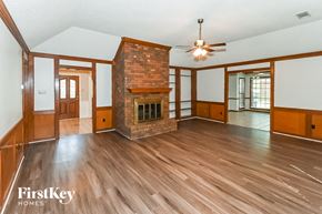 Germantown house for rent - A spacious living room with wood flooring and a brick fireplace.