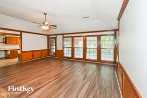 Germantown house for rent - A spacious room with wooden floors and a ceiling fan.