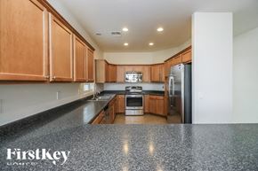 San Tan Valley house for rent - A kitchen with wooden cabinets and a granite countertop.