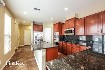 Glendale house for rent - a kitchen with granite counter tops and wooden cabinets