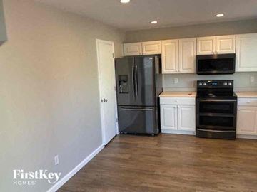 Thornton house for rent - a kitchen with stainless steel appliances and white cabinets