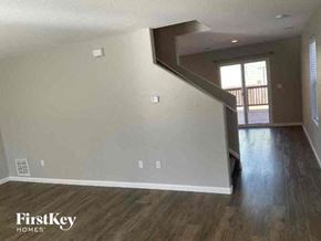Thornton house for rent - an empty living room with wood floors and a staircase