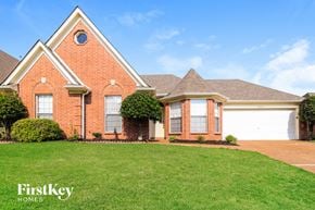 Cordova house for rent - a brick house with a lawn in front of it
