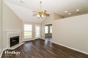 Cordova house for rent - a living room with a fireplace and a ceiling fan