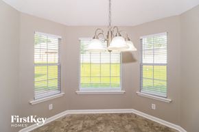 Cordova house for rent - an empty dining room with three windows and a chandelier