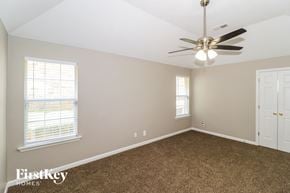 Cordova house for rent - an empty bedroom with a ceiling fan and window
