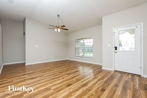 Clermont house for rent - a living room with hardwood floors and a white door