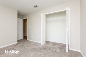 Clermont house for rent - a bedroom with a closet and an open doorway to a closet