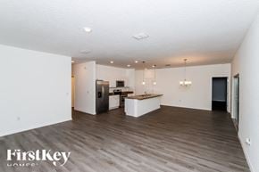 Palm Bay house for rent - A spacious kitchen with a wooden floor and white walls.