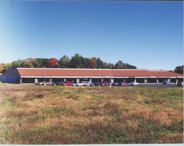 Saugerties apartment for rent - a red barn with cars parked in a field
