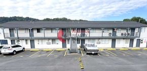Longview apartment for rent - A white building with a red logo on the side.