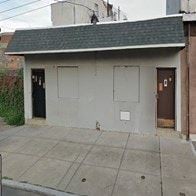 Philadelphia apartment for rent - A small building with a grey roof and a brown door.