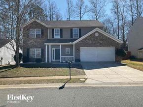 Charlotte house for rent - a house with a white garage door on a street