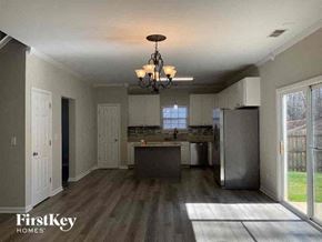 Charlotte house for rent - an empty kitchen with a stainless steel refrigerator
