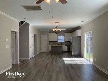 Charlotte house for rent - a living room with a kitchen and a ceiling fan