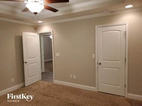 Gainesville house for rent - a living room with two doors and a ceiling fan