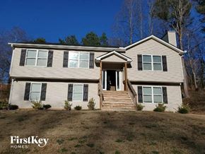 Gainesville house for rent - a white house with black shutters and a yard