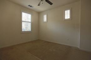 Livermore house for rent - A room with a ceiling fan and two windows.