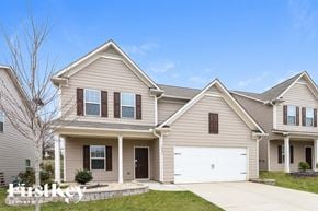 Pendergrass house for rent - a beige house with a white garage door