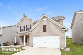 Pendergrass house for rent - a beige house with a white garage door