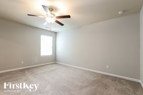Pendergrass house for rent - a bedroom with carpet and a ceiling fan