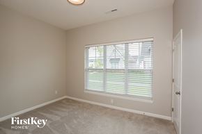Westfield house for rent - a bedroom with a large window and a carpeted floor